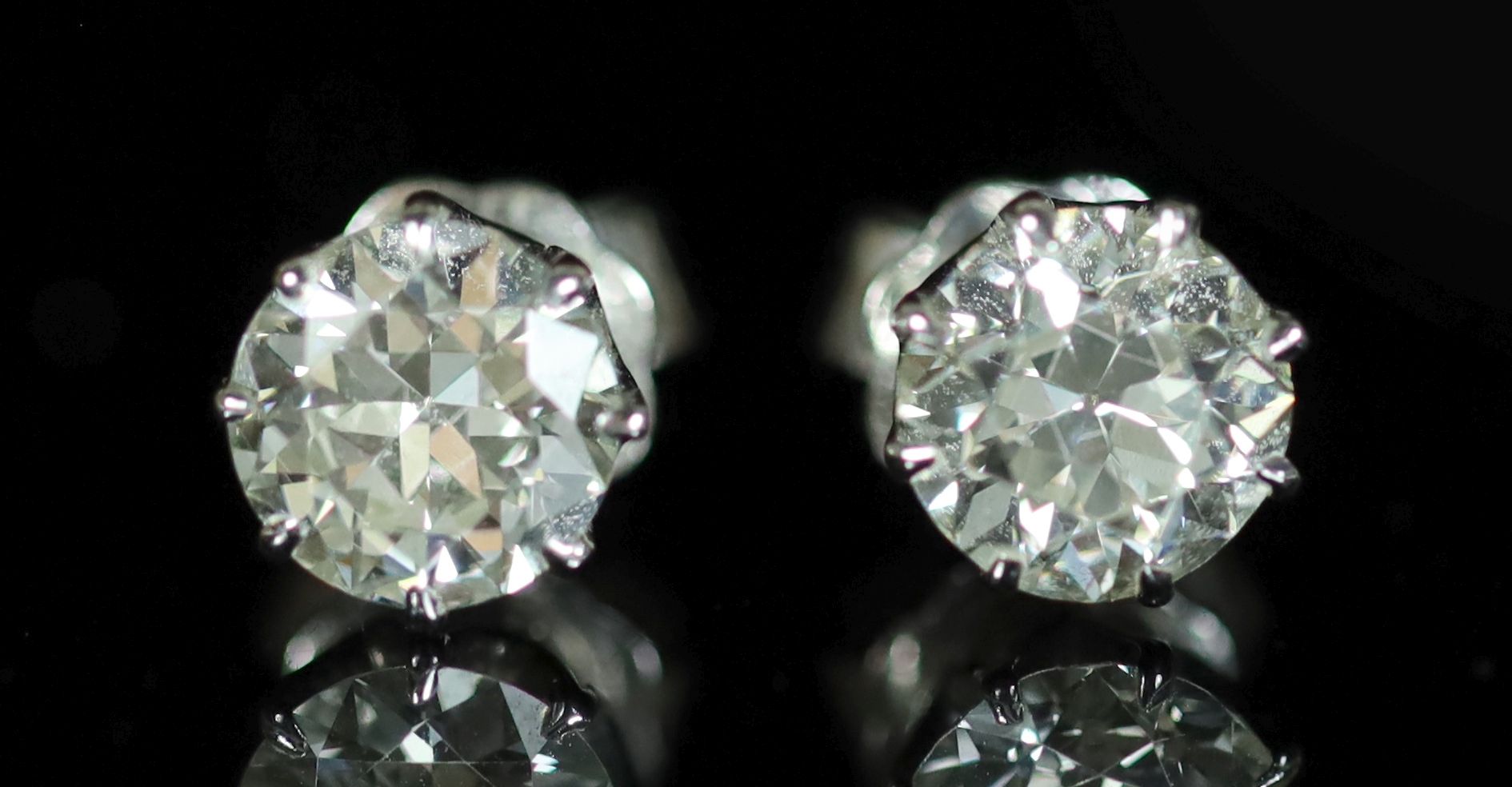 A pair of white gold and diamond stud earrings, the diamonds each approximately 0.75ct,